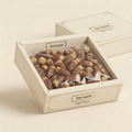 AI-generated Awoam Sagai Dates packaging concept in an ivory carton enclosed in a clear flexible bag.